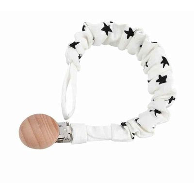 l'attache tetine de couleur blanche avec étoiles noires
