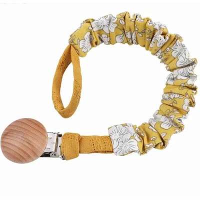 l'attache tetine de couleur jaune